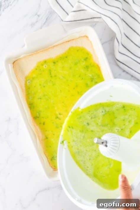 pouring lime bar batter onto crust in baking dish.