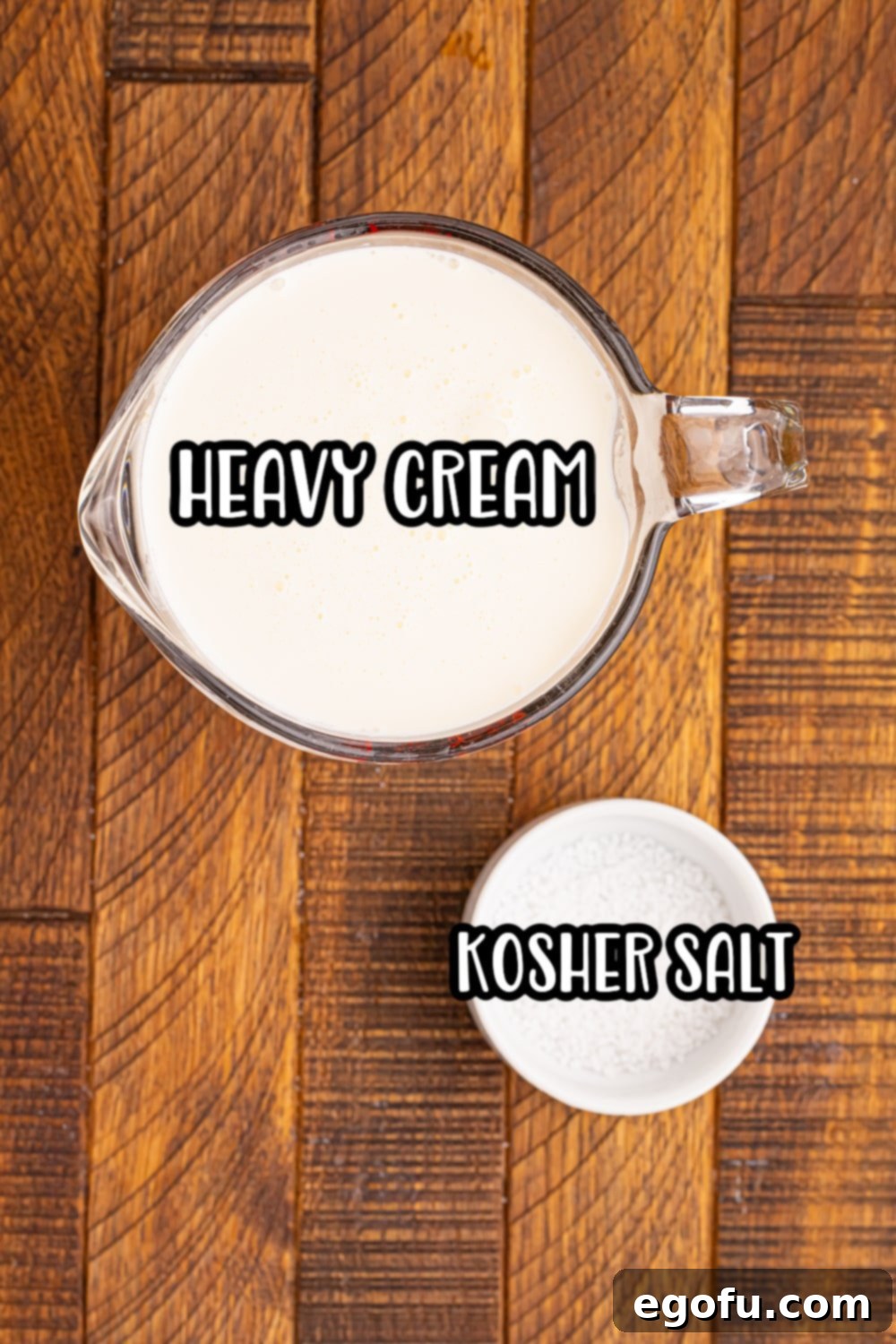 Close-up of the two simple ingredients for whipped butter: a carton of heavy cream and a small bowl of kosher salt.