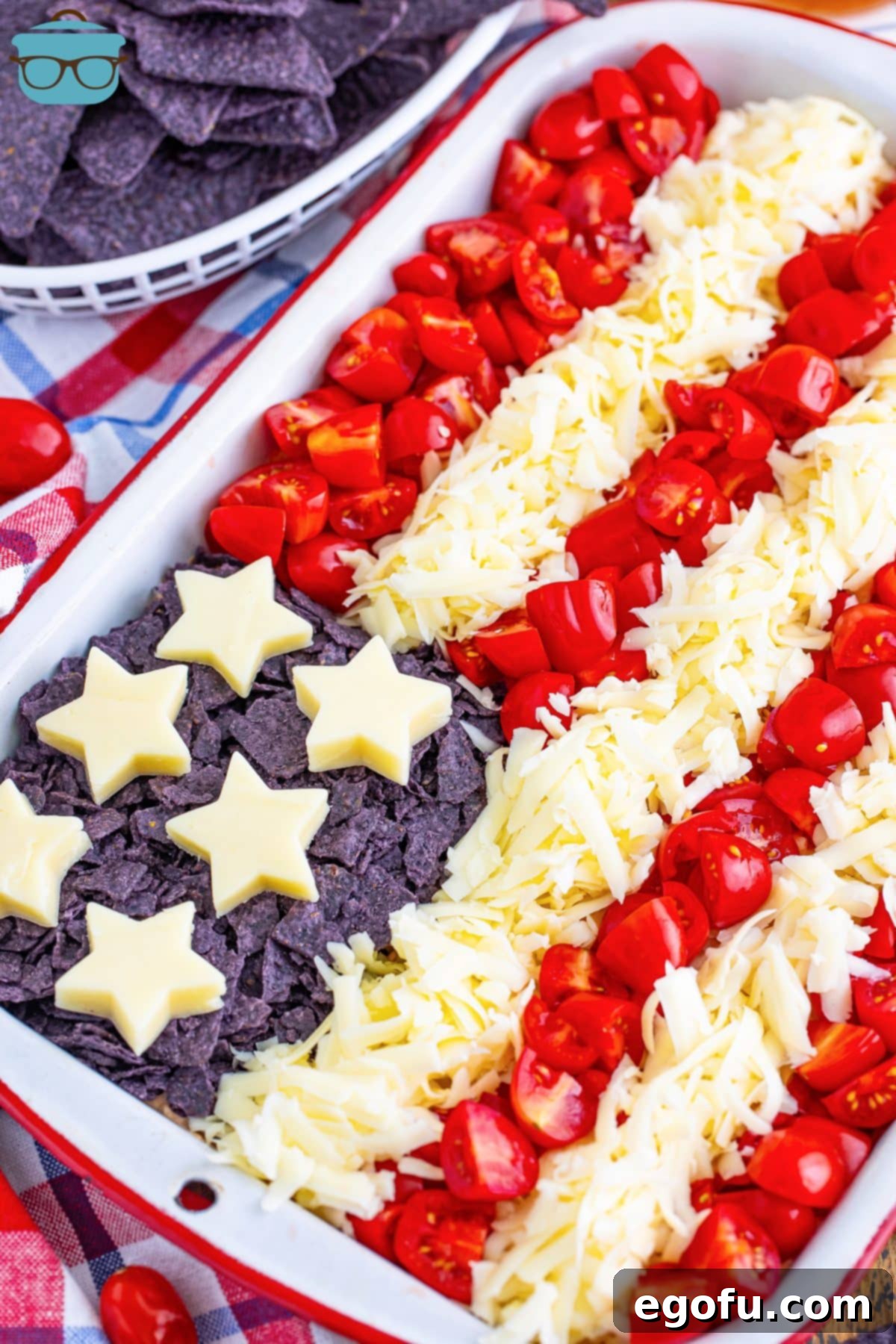 Stars and Stripes Celebration Dip 2 A beautifully arranged horizontal 4th of July Flag Taco Dip in a rectangular baking dish, ready for patriotic celebrations.