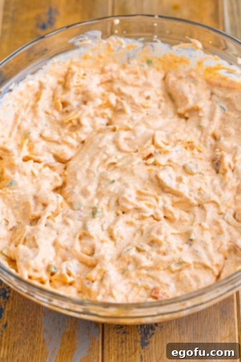 Stars and Stripes Celebration Dip 13 A dip of cream cheese, salsa, sour cream, cheddar, green onions, and taco seasoning blended together in a bowl.