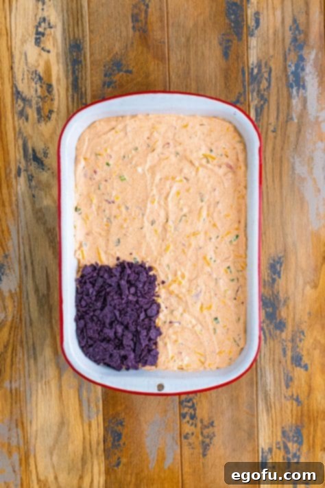 Stars and Stripes Celebration Dip 17 Blue tortilla chips crushed up in a small rectangle on top of taco dip.