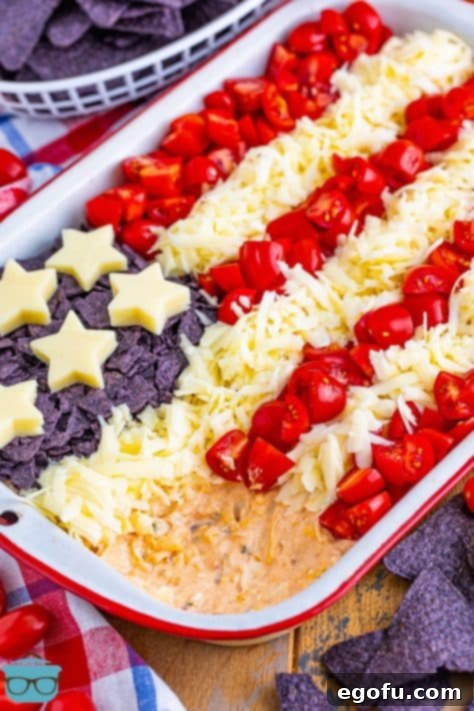 Stars and Stripes Celebration Dip 22 A baking dish with a 4th of July Flag Dip and a section of it missing.