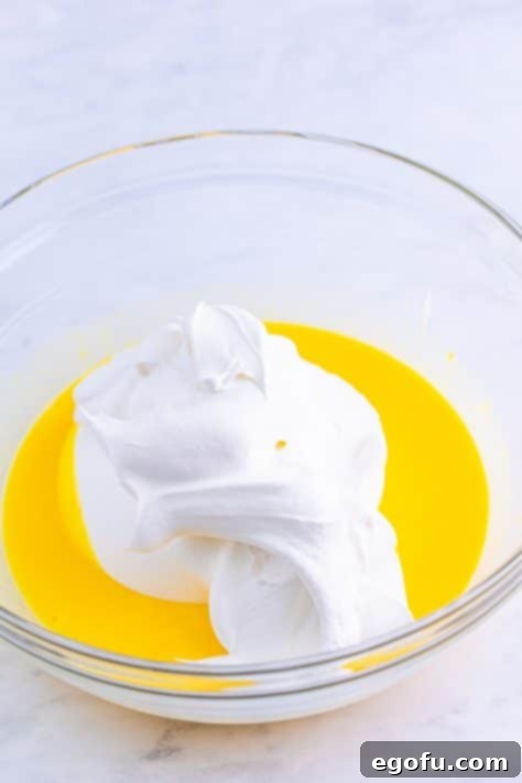 Cool whip in a pudding mixture in a bowl.