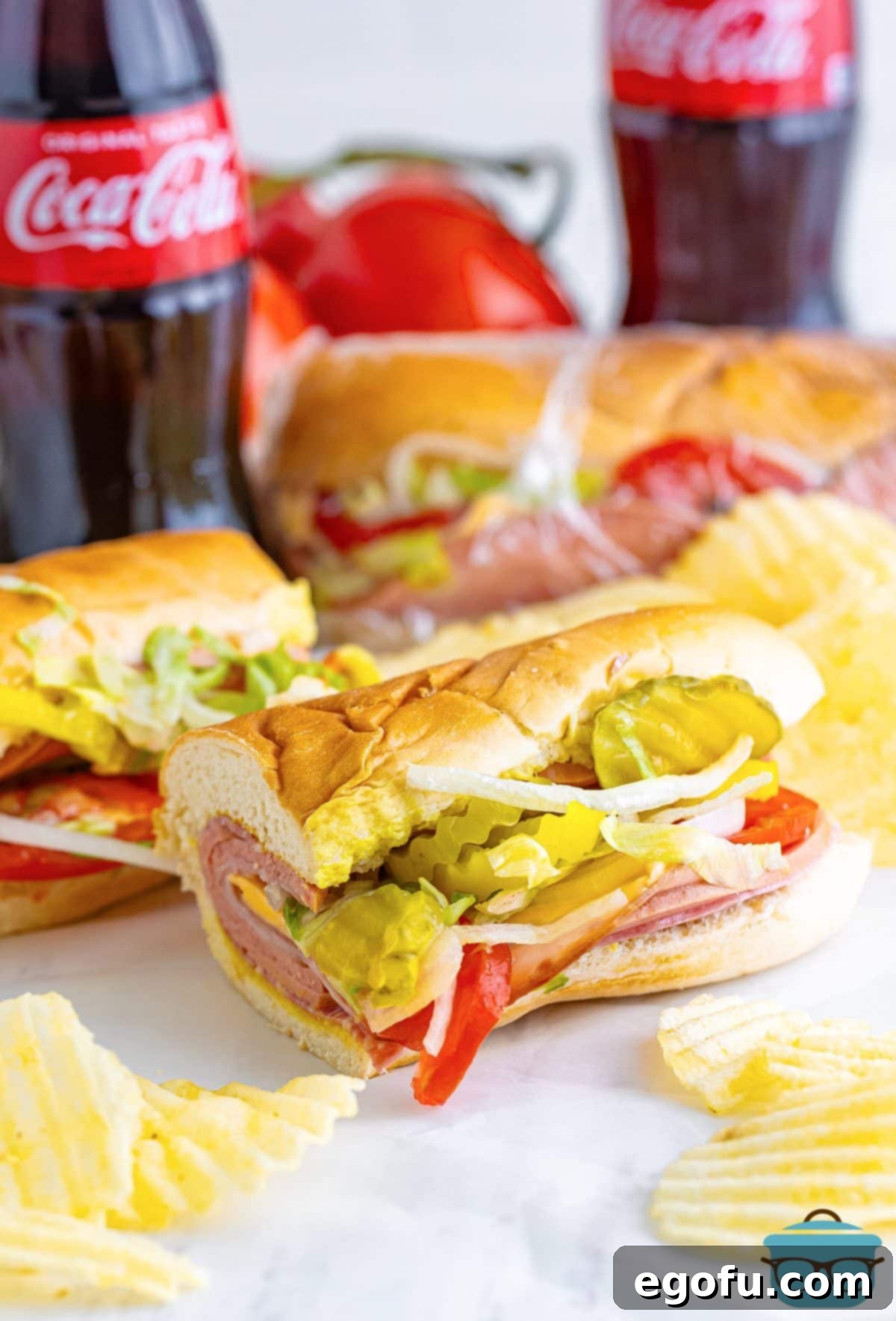 A captivating shot featuring several freshly made Kmart Subs, artfully arranged alongside a couple of chilled Coke bottles, evoking a nostalgic and refreshing lunchtime scene.