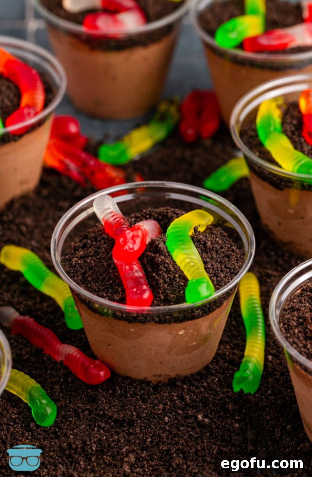 A bunch of Dirt Cups with gummy worms in them.