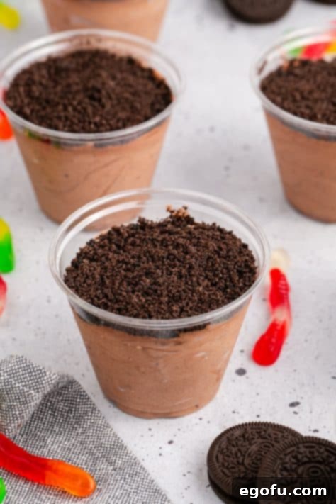 Cookie crumbs on top of chocolate pudding in cups.