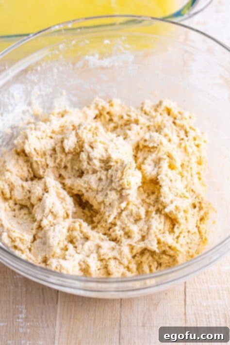 Golden Butter Soaked Cinnamon Sugar Biscuits 12 A sticky batter for Cinnamon Sugar Butter Swim Biscuits in a bowl.