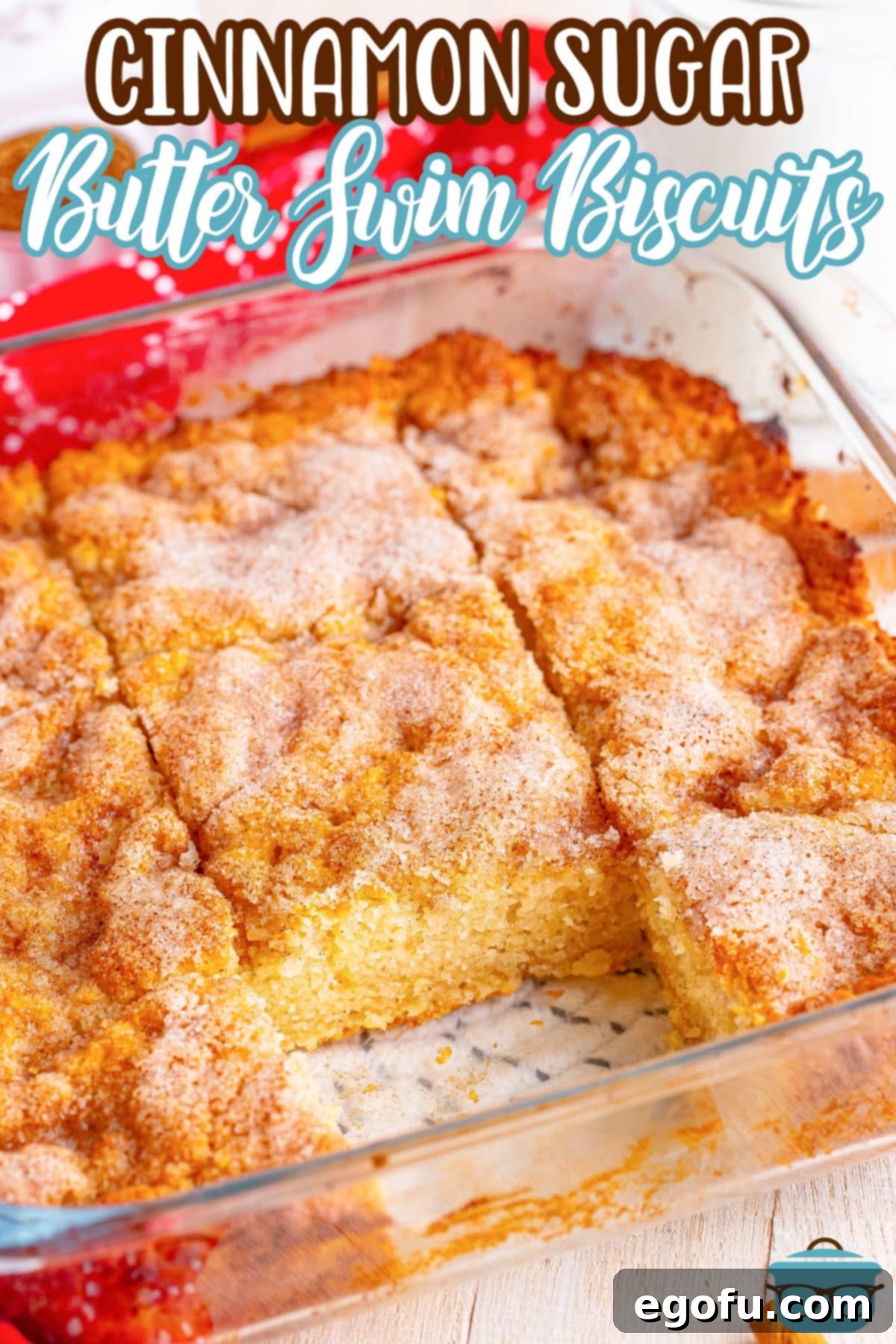 Golden Butter Soaked Cinnamon Sugar Biscuits 3 A baking dish of Cinnamon Sugar Butter Swim Biscuits with one piece removed, showcasing the delightful texture.