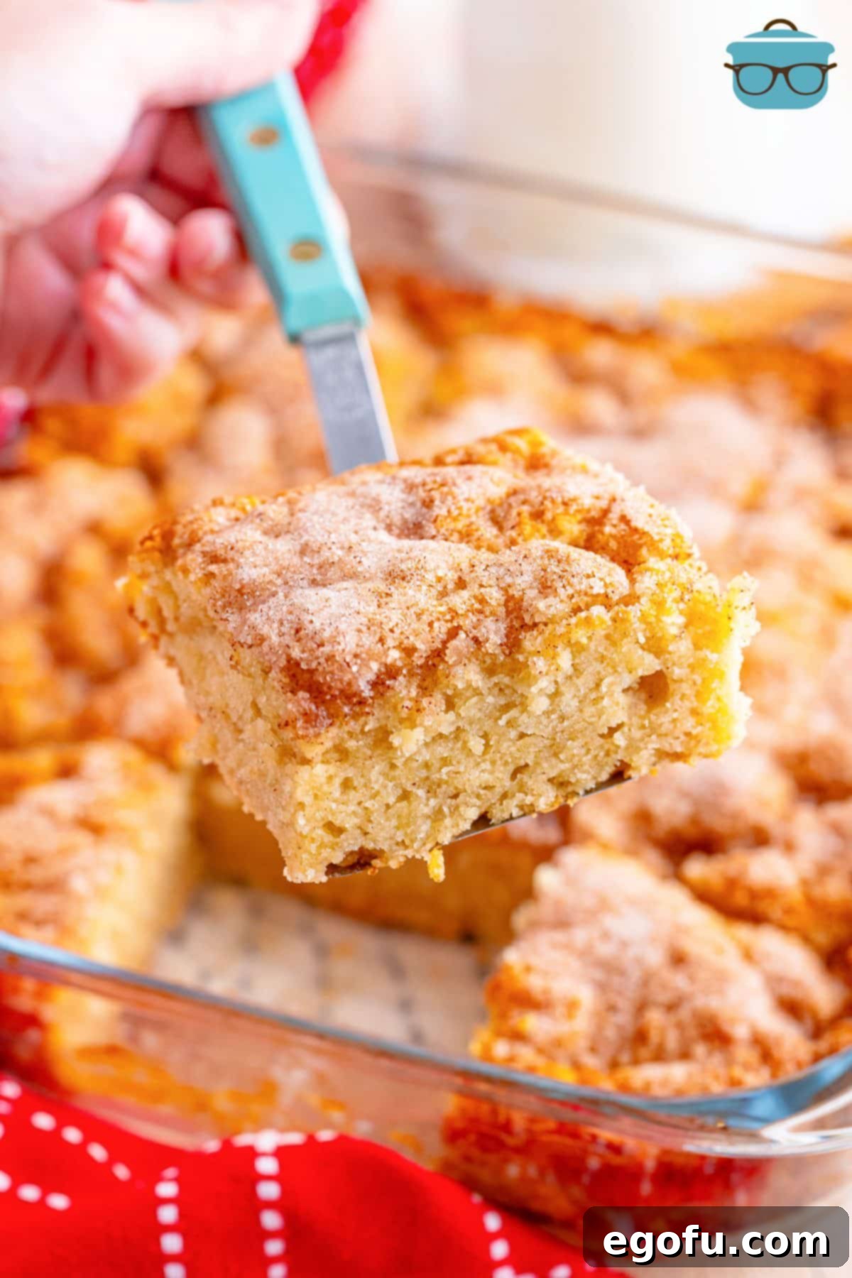Golden Butter Soaked Cinnamon Sugar Biscuits 8 A serving utensil holding a freshly baked Cinnamon Sugar Butter Swim Biscuit.