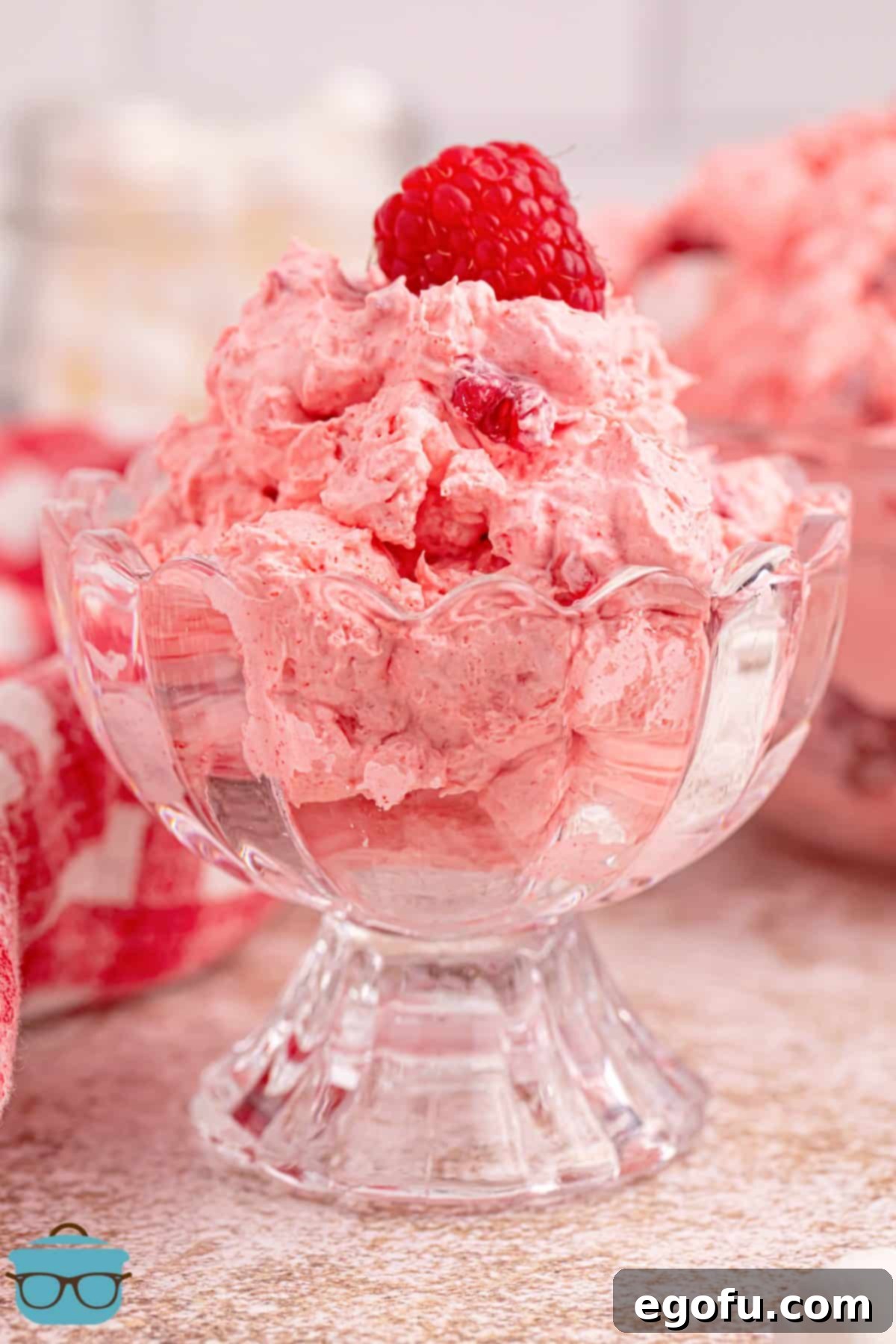 A dessert serving bowl of Raspberry Fluff, showcasing its vibrant color and fluffy texture.