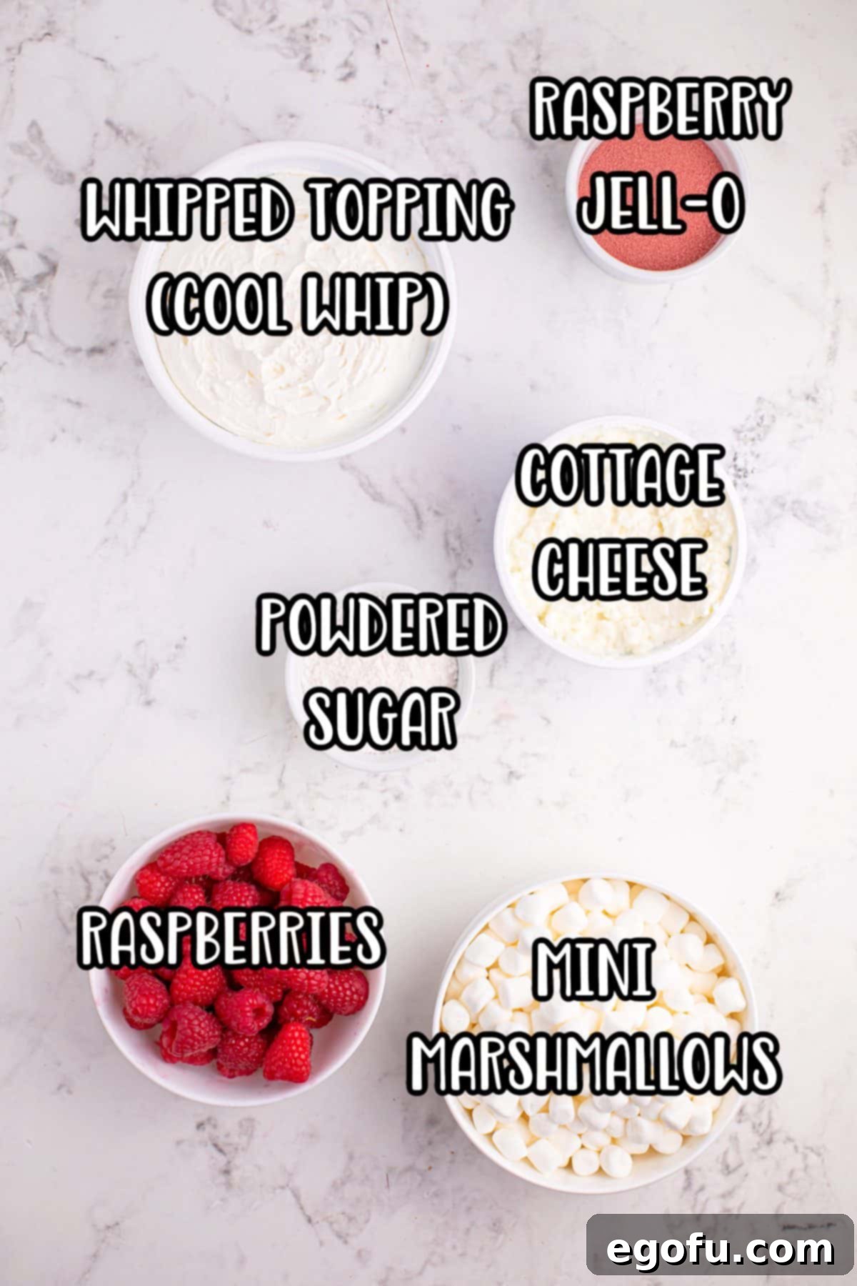 A vibrant collage showing all the ingredients for Raspberry Fluff: whipped topping, raspberry gelatin, cottage cheese, fresh raspberries, powdered sugar, and mini marshmallows.