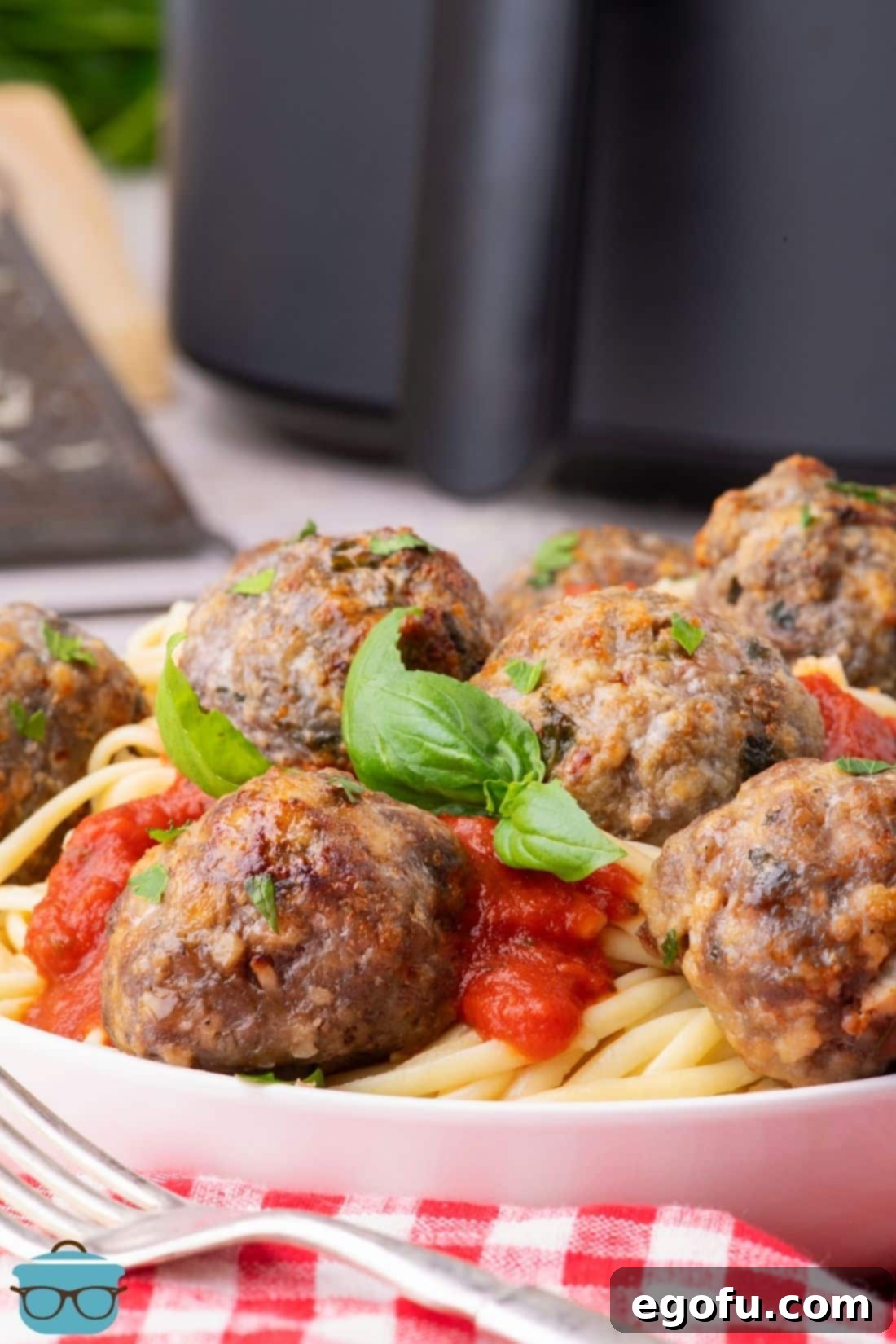 Effortlessly Delicious Air Fryer Meatballs 2 A plate of pasta with red sauce and Air Fryer Meatballs.