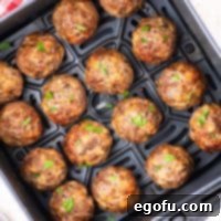 Effortlessly Delicious Air Fryer Meatballs 11 Looking down on an Air Fryer basket of Air Fryer Meatballs.