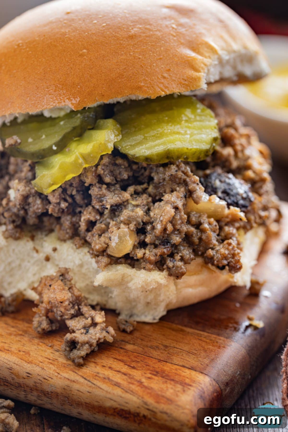 Crumble Burger 8 closeup photo of a Maid Rite Loose Meat Sandwich on a wood board.