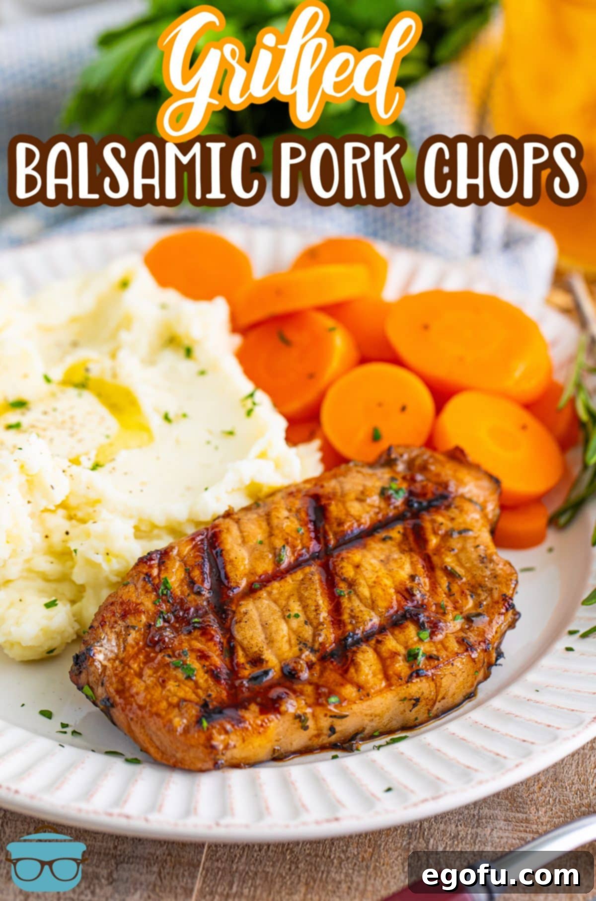 A plate featuring perfectly grilled balsamic pork chops, served alongside creamy mashed potatoes and vibrant glazed carrots.
