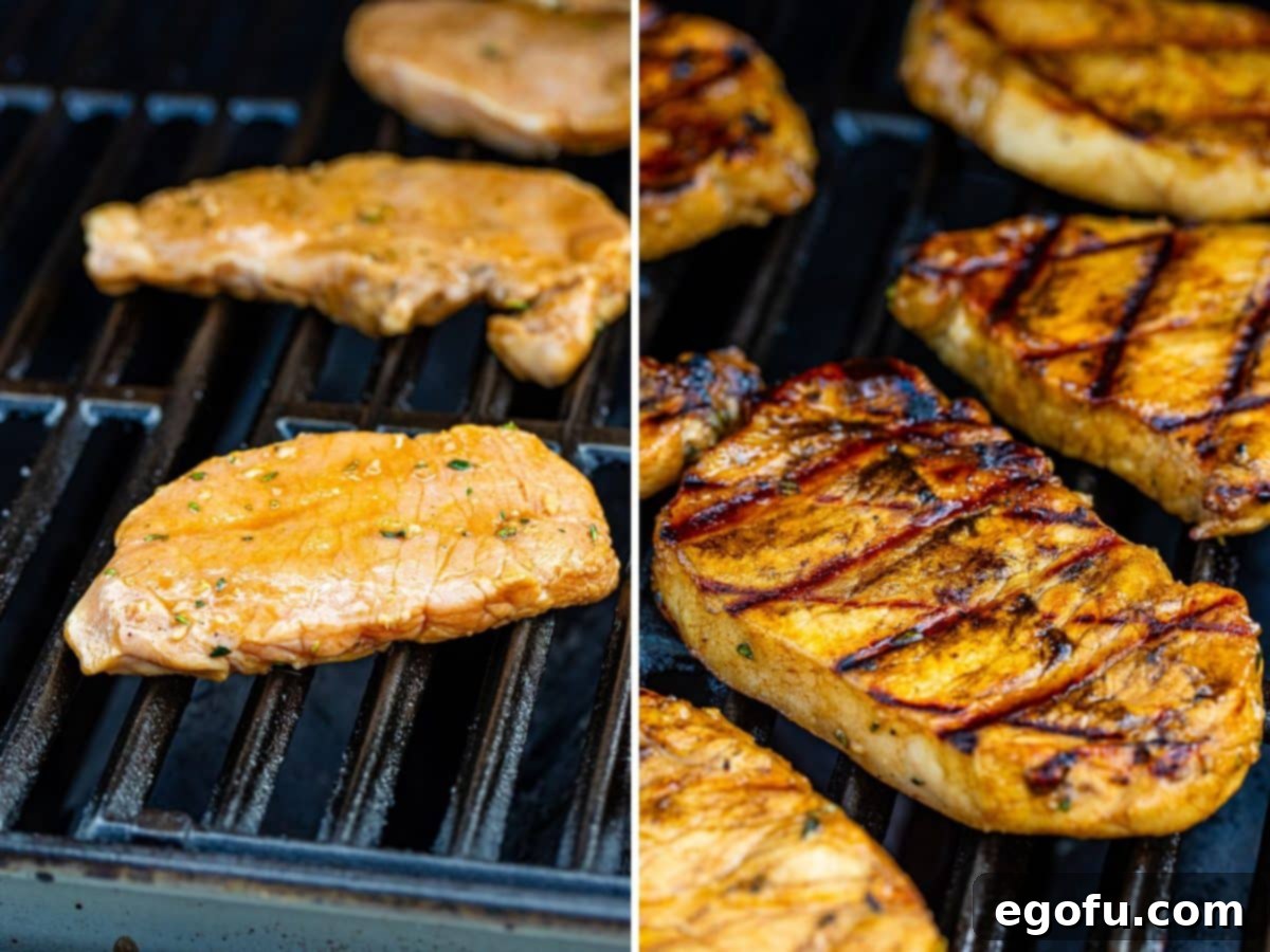 Pork chops cooking on the grill, showing one side with beautiful grill marks after being flipped, ready for more delicious char.