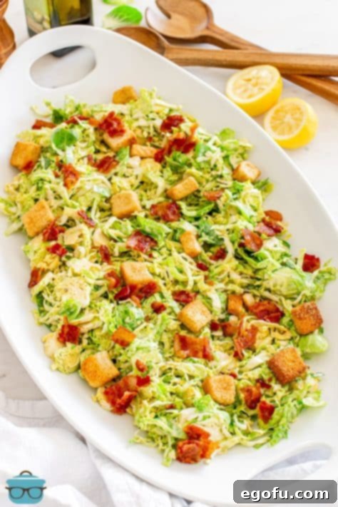 A large platter of Brussels Sprouts Caesar Salad.