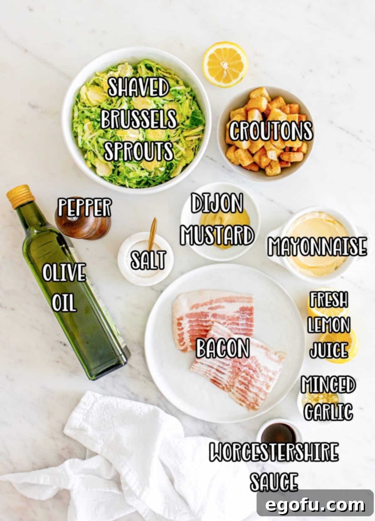 Croutons, salt, olive oil, bacon, mayo, Dijon mustard, lemon juice, Worcestershire sauce, minced garlic cloves, black pepper, and shaved Brussels sprouts.
