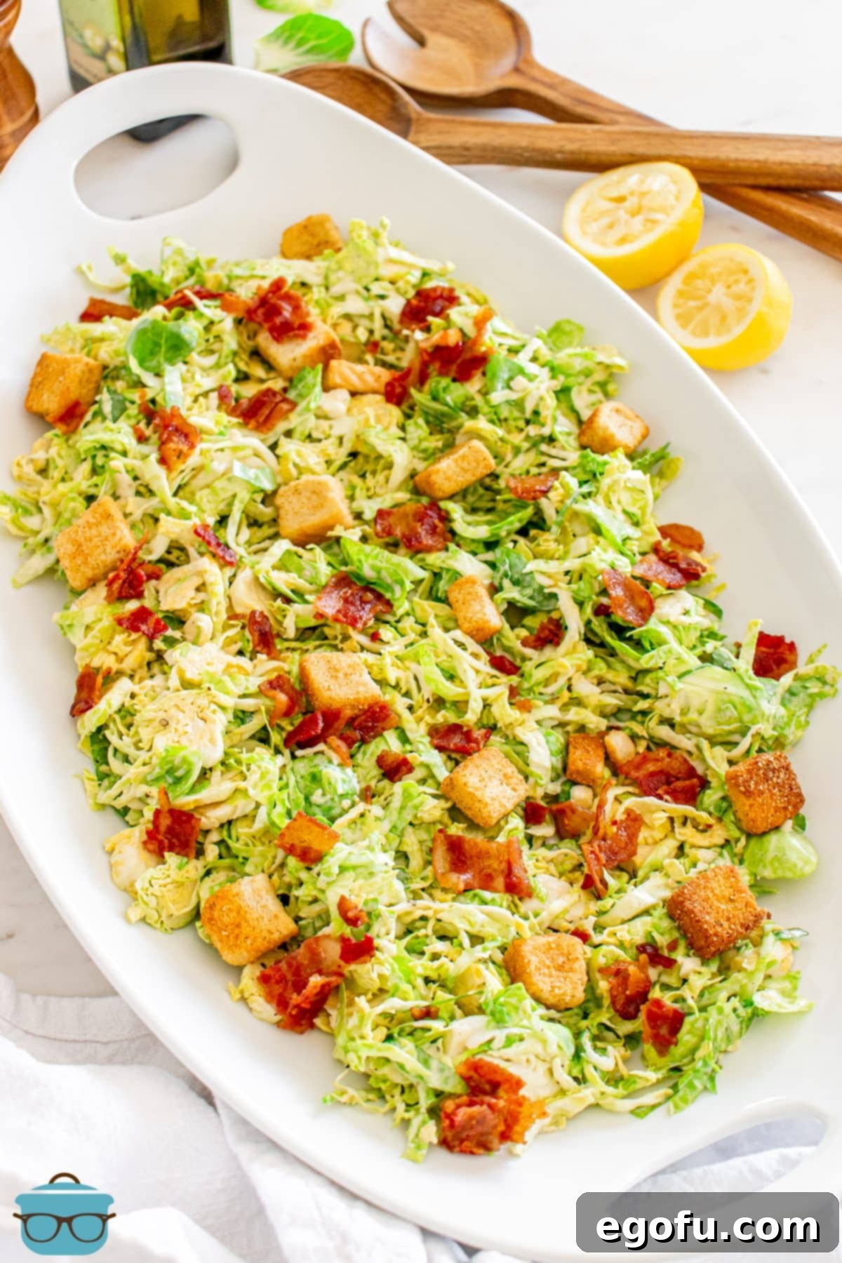 A large platter of Brussels Sprouts Caesar Salad.