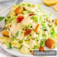 A plate with a large serving of Brussels Sprouts Caesar Salad.