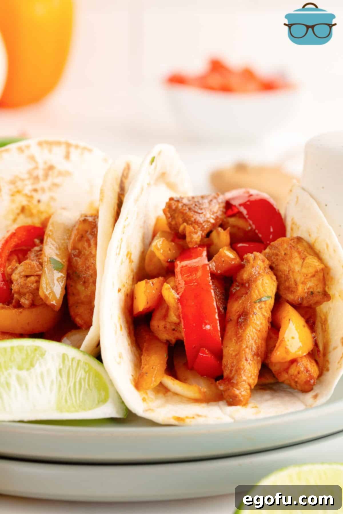 A few homemade Chicken Fajitas in tortillas, garnished with fresh cilantro.