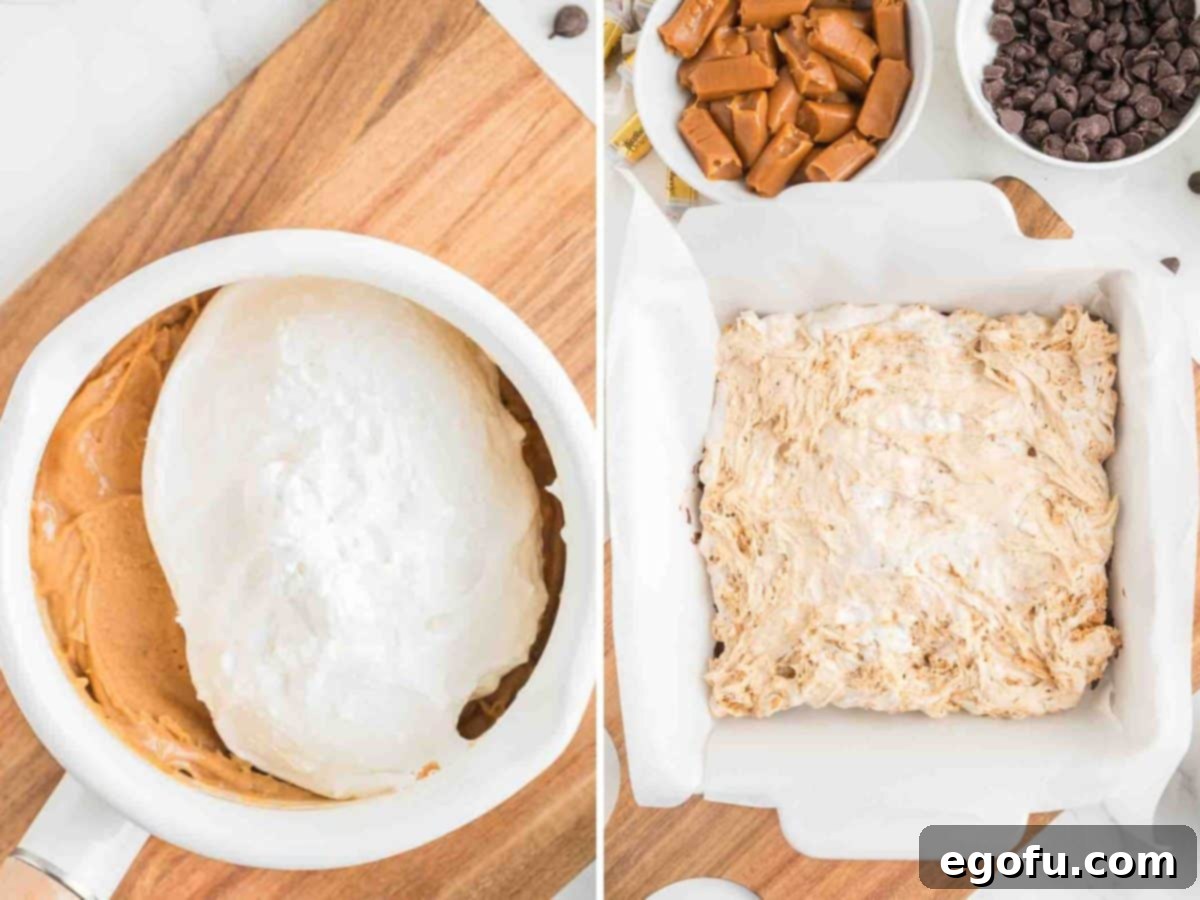 The peanut butter and marshmallow creme mixture being added as the second layer to the baking dish.