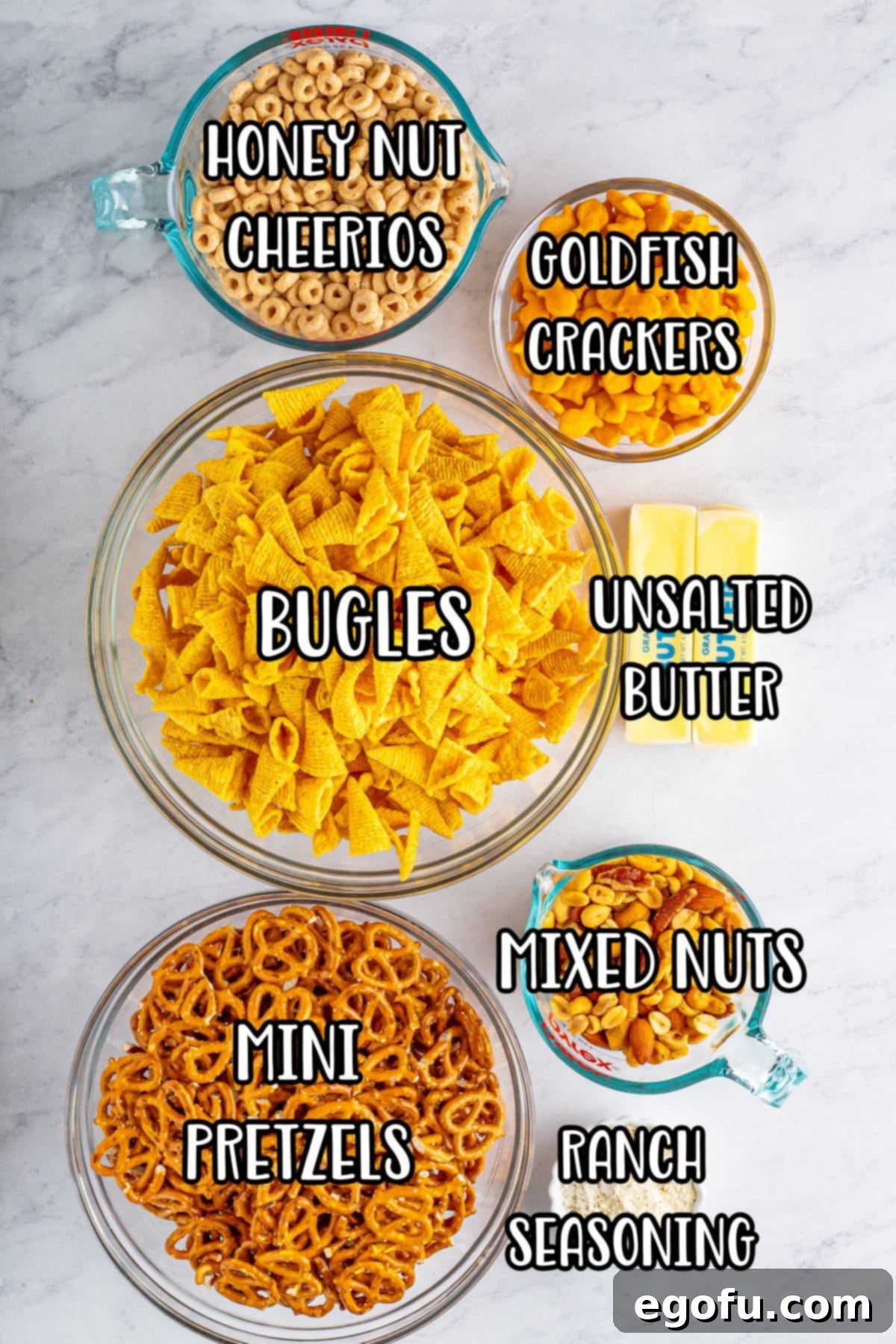 Butter, ranch seasoning, mixed nuts, Goldfish, mini pretzels, and Honey Nut Cheerios.