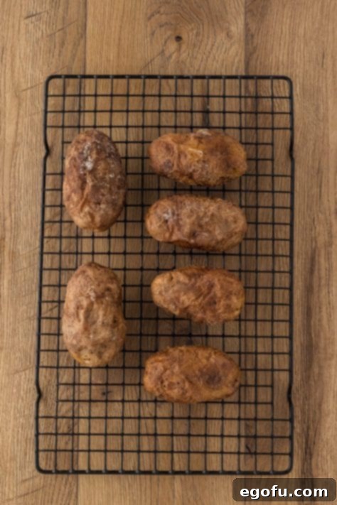 A few potatoes on a wire rack.