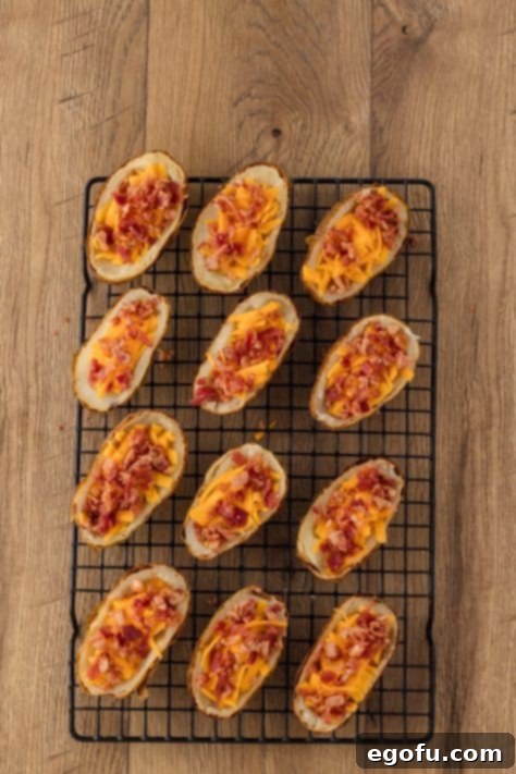 Potatoes loaded with toppings on a wire rack.