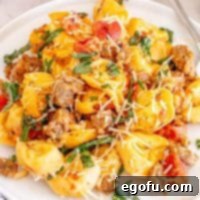 Creamy One-Pot Sausage Tortellini 8 Looking closely at a pile of creamy One Pot Sausage Tortellini in a bowl, ready to eat.