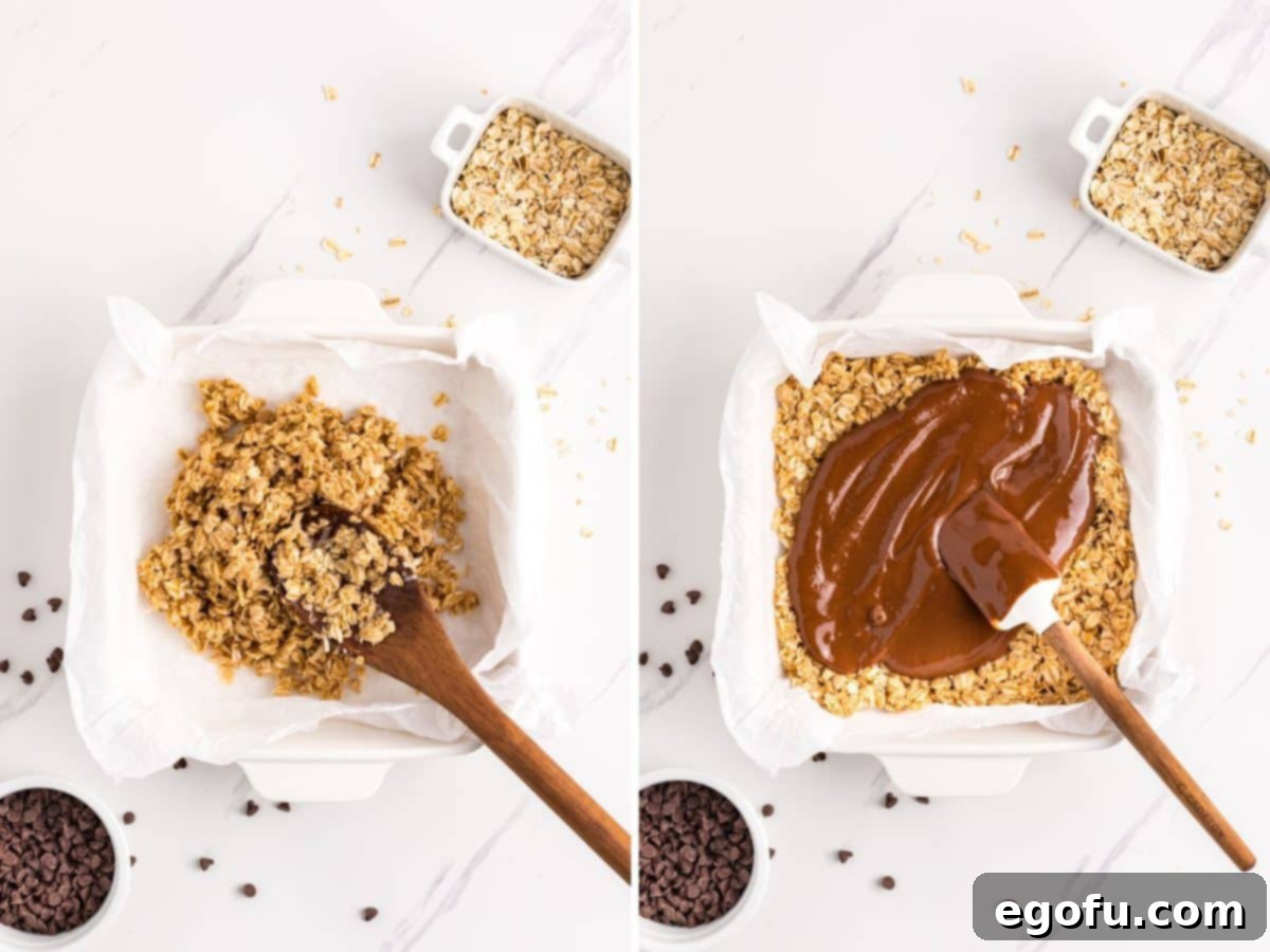 A baking dish with a firm oat mixture base, and the rich chocolate peanut butter mixture being poured and spread over it, creating the second layer.