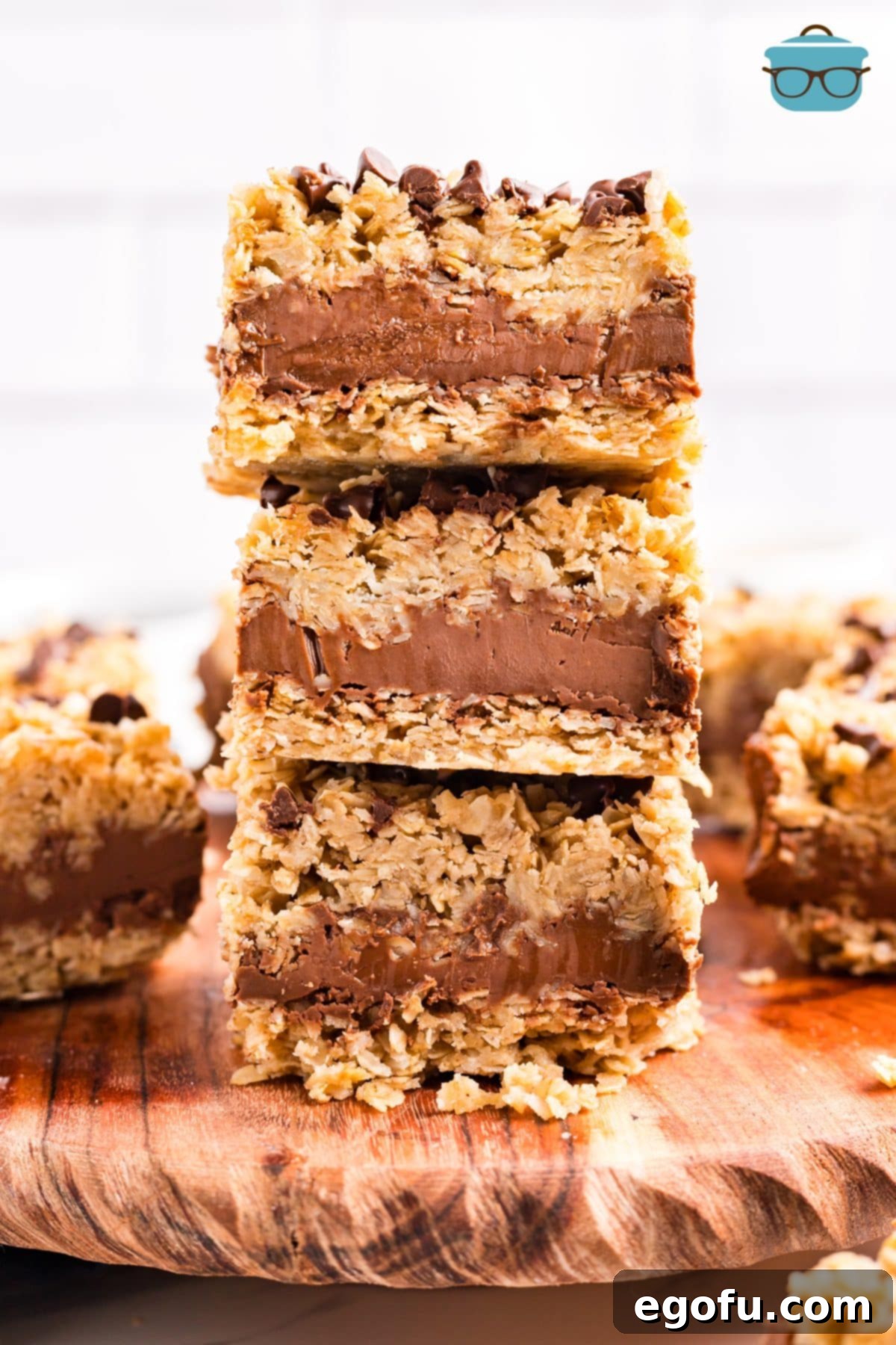 A beautifully stacked trio of No Bake Chocolate Peanut Butter Oatmeal Bars, perfectly chilled and ready for serving, showcasing their delicious layers.