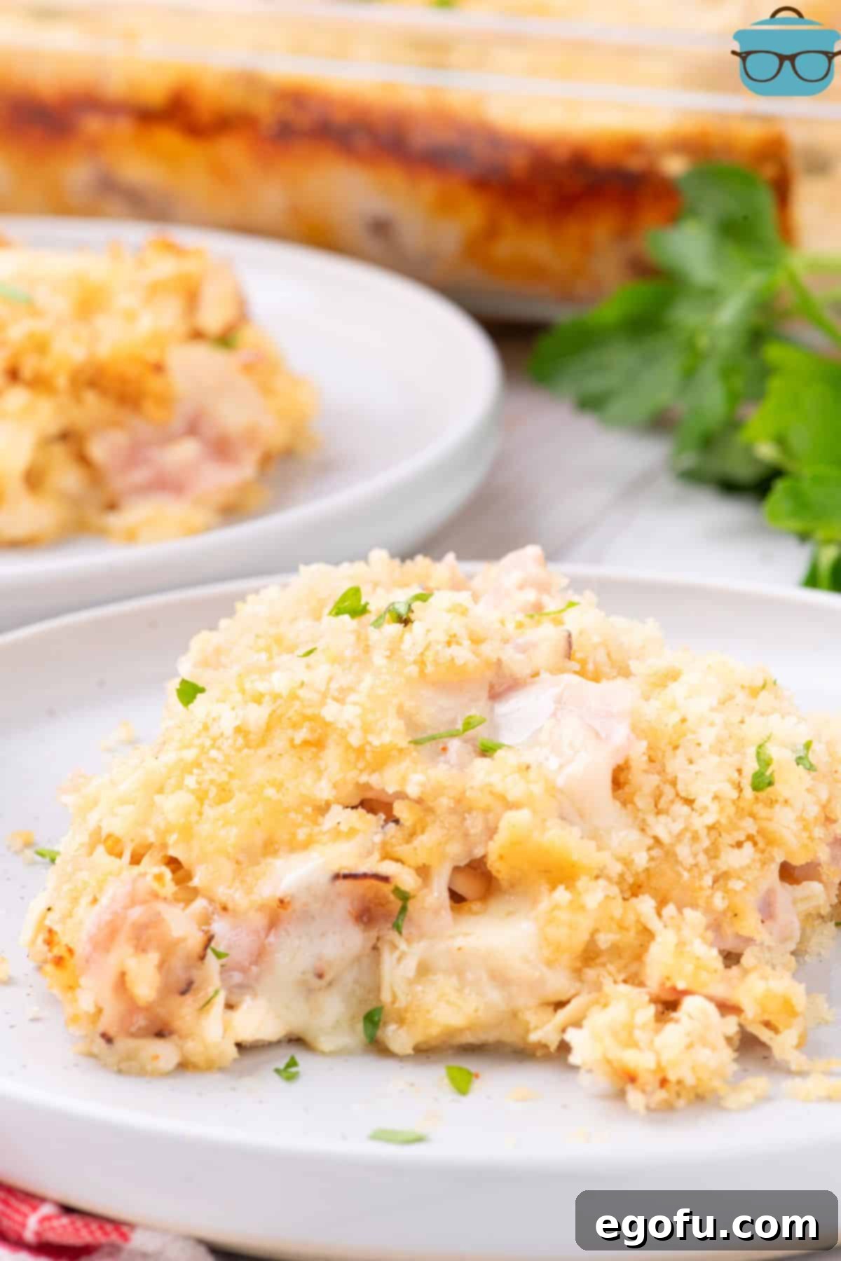 Golden Baked Chicken Ham and Swiss Casserole 2 A large serving of Chicken Cordon Bleu Casserole on a plate, showcasing its golden topping and creamy interior.