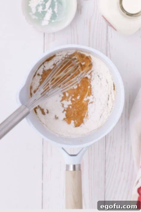 Golden Baked Chicken Ham and Swiss Casserole 16 Flour added to a mixture in a saucepan.