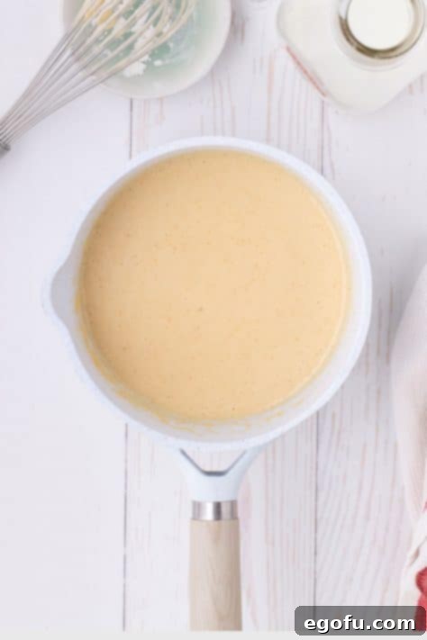 Golden Baked Chicken Ham and Swiss Casserole 18 A smooth creamy sauce in a saucepan.