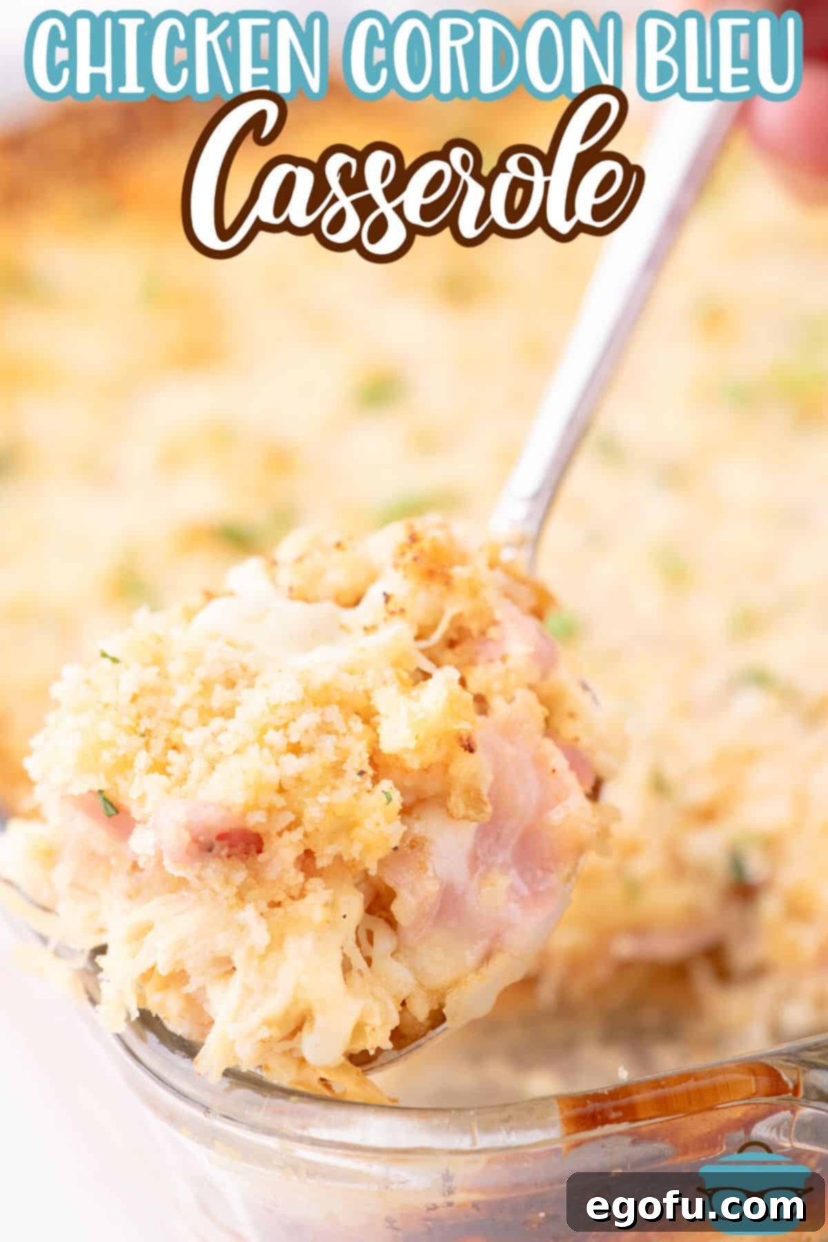 Golden Baked Chicken Ham and Swiss Casserole 3 A serving utensil getting a scoop of creamy Chicken Cordon Bleu Casserole from a baking dish.