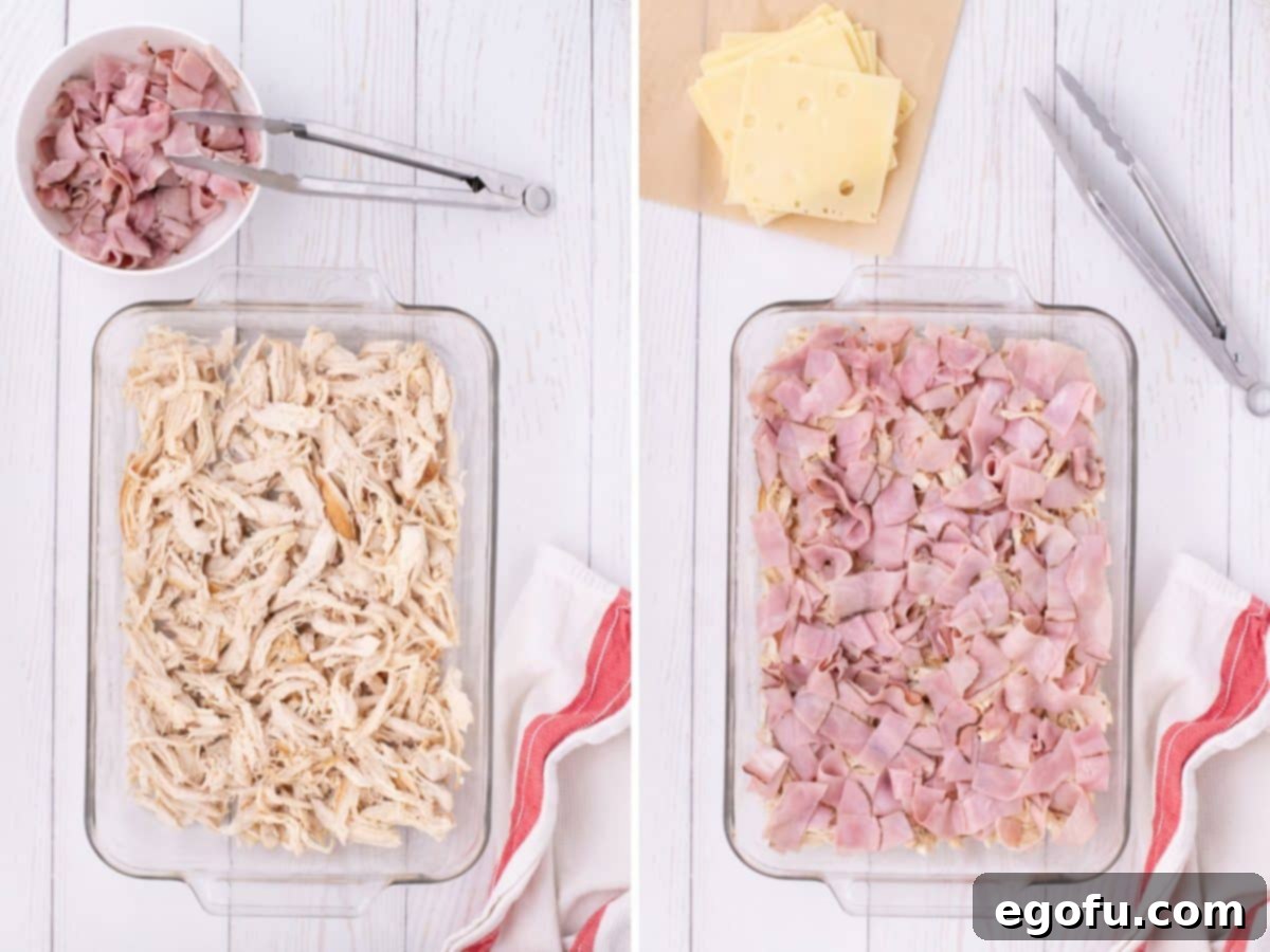 Golden Baked Chicken Ham and Swiss Casserole 5 A baking dish with a uniform layer of shredded chicken, ready for the next step.