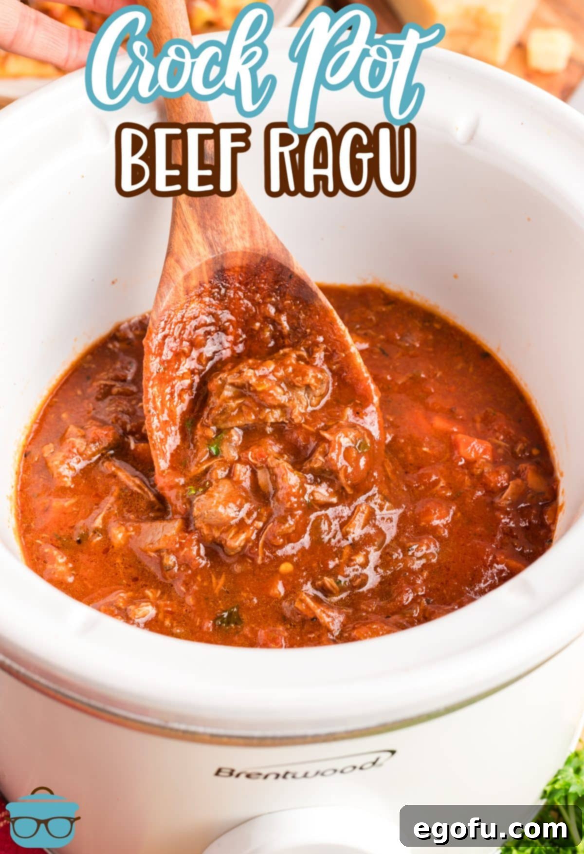 A spoon stirring the Crock Pot Beef Ragu sauce.