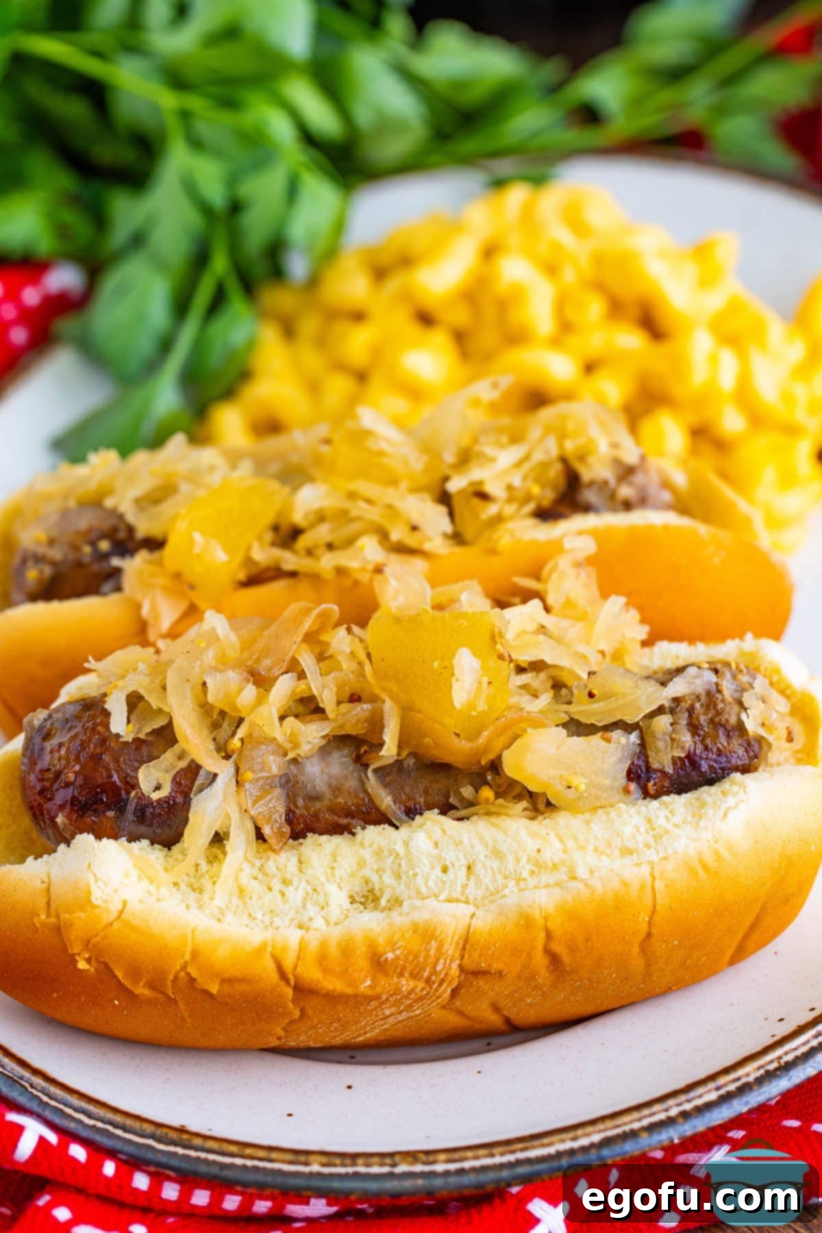 Hearty Slow Cooker Brats with Sauerkraut 2 A few Crock Pot Brats on a plate, ready to be served.