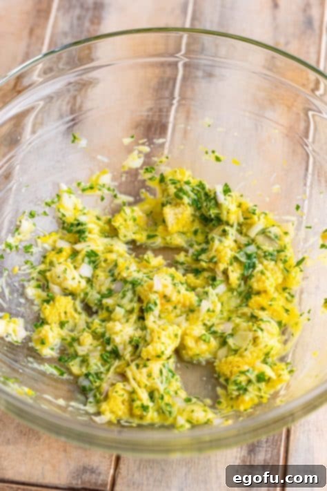 Zesty Piccata Chicken Bites 14 A large mixing bowl with torn white bread, milk, parmesan cheese, egg, shallot, lemon zest, salt, and parsley.