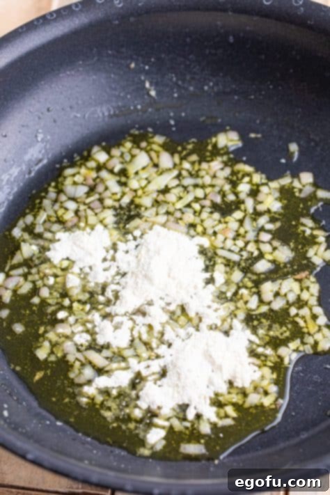 Zesty Piccata Chicken Bites 19 Flour being added to oil and shallots.