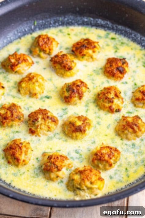 Zesty Piccata Chicken Bites 22 Meatballs simmering in cream sauce.