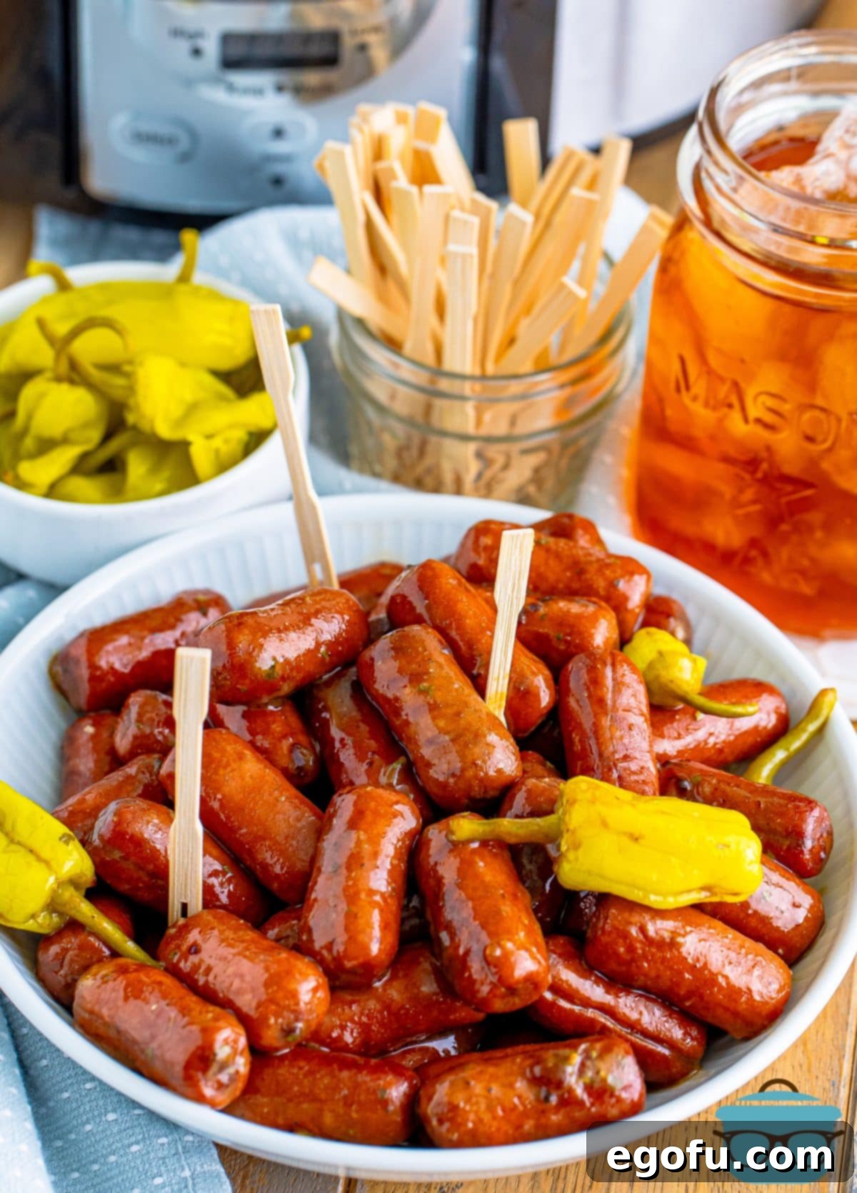 Irresistible Slow Cooker Mississippi Sausages 2 A beautifully arranged bowl of Crock Pot Mississippi Lit'l Smokies, garnished and ready to serve.