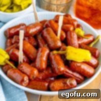 Irresistible Slow Cooker Mississippi Sausages 8 Looking down on a bowl of Crock Pot Mississippi Lit'l Smokies, garnished with fresh parsley and ready to serve.