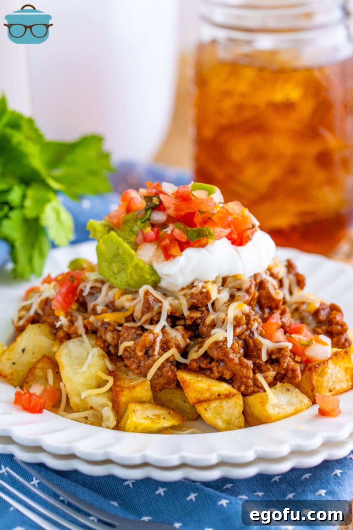 A close-up shot of a plate brimming with freshly made Taco Potatoes, garnished with toppings.