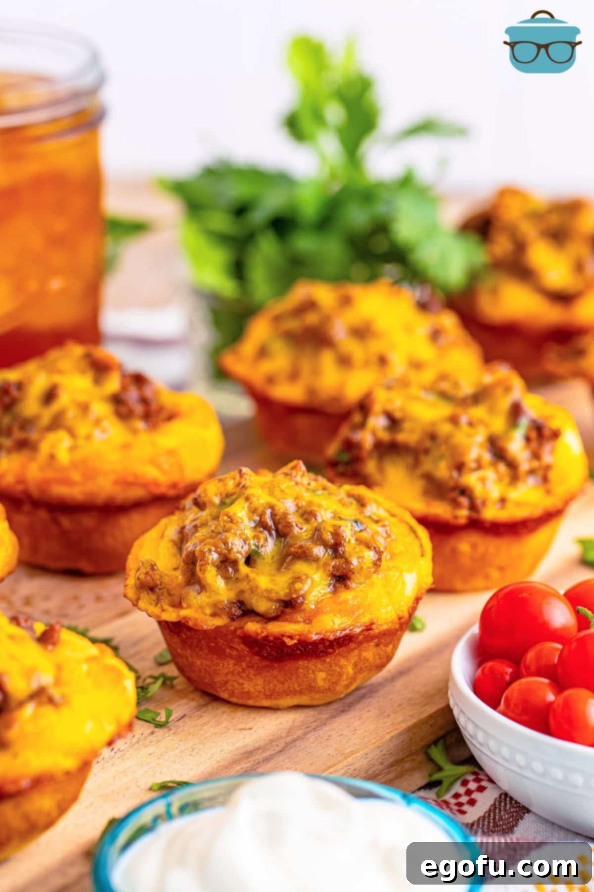 A handful of freshly baked Taco Biscuit Cups, golden brown and cheesy.
