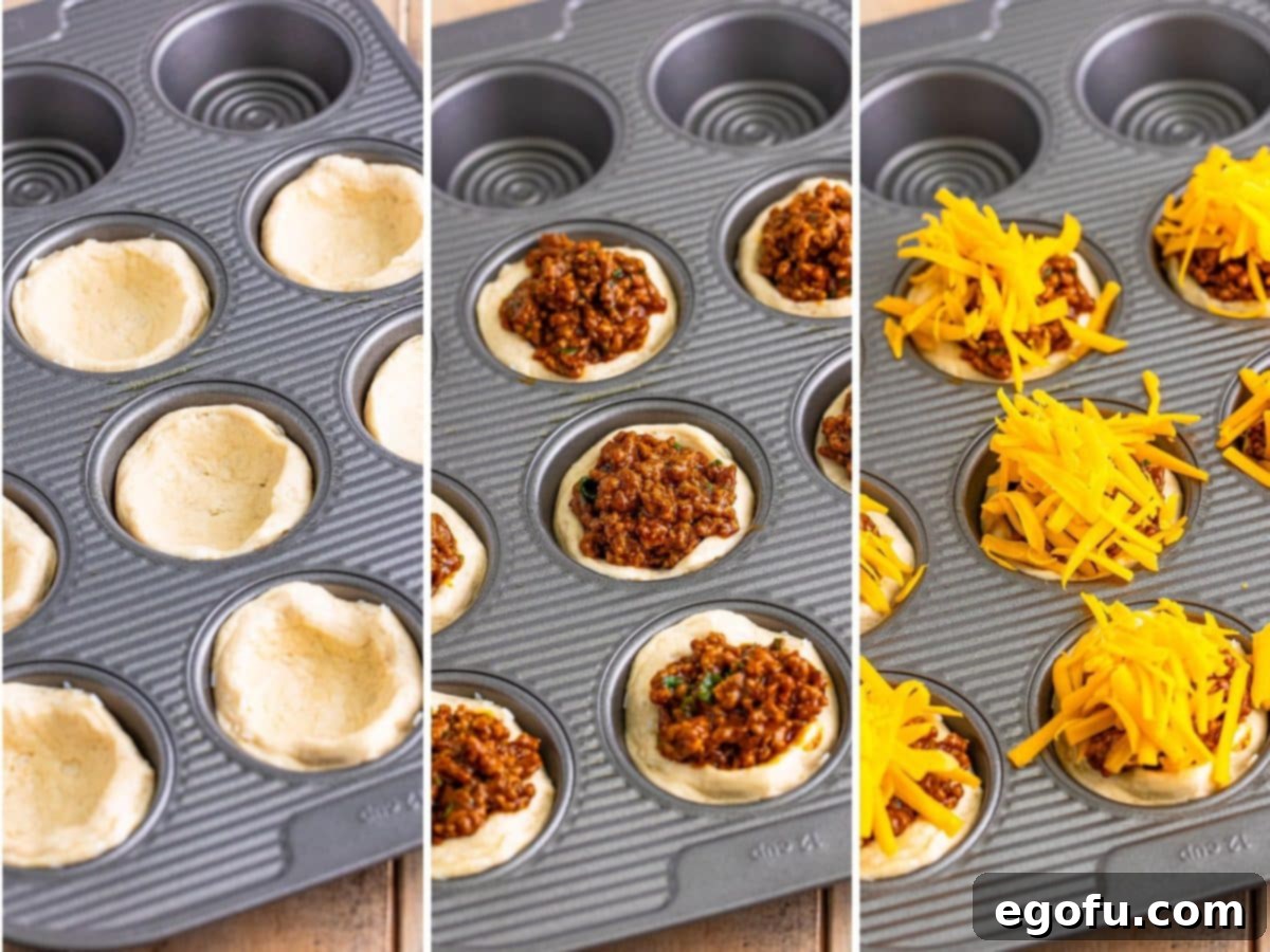 Biscuit dough pressed into the wells of a muffin tin, ready for filling.