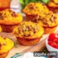 A few Taco Biscuit Cups on a wooden board, ready to be served.