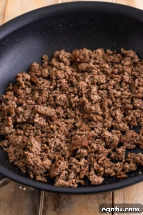 Cooked ground beef in a skillet.
