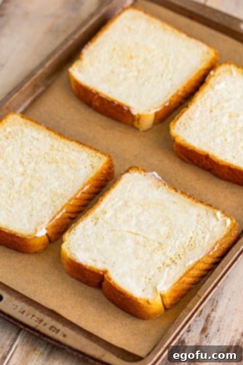 Buttered Texas toast on a sheet.